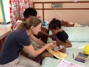 Kirsten Finucane treats a young patient in Fiji
